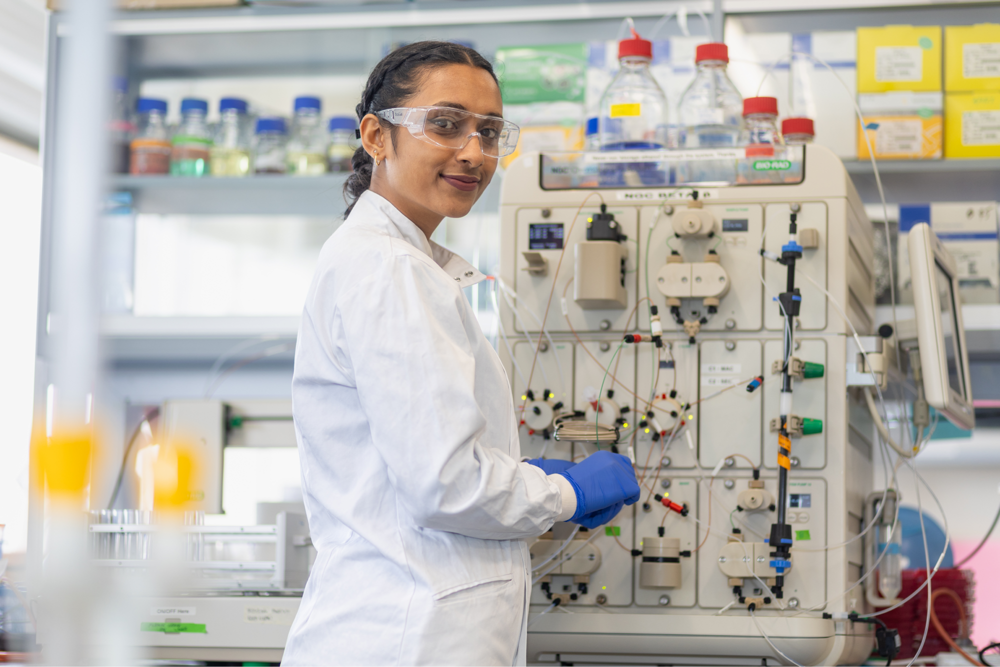 student-smiling-using-lab-equipment