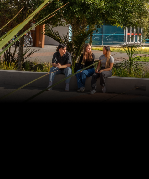 three-students-sitting-outside-library