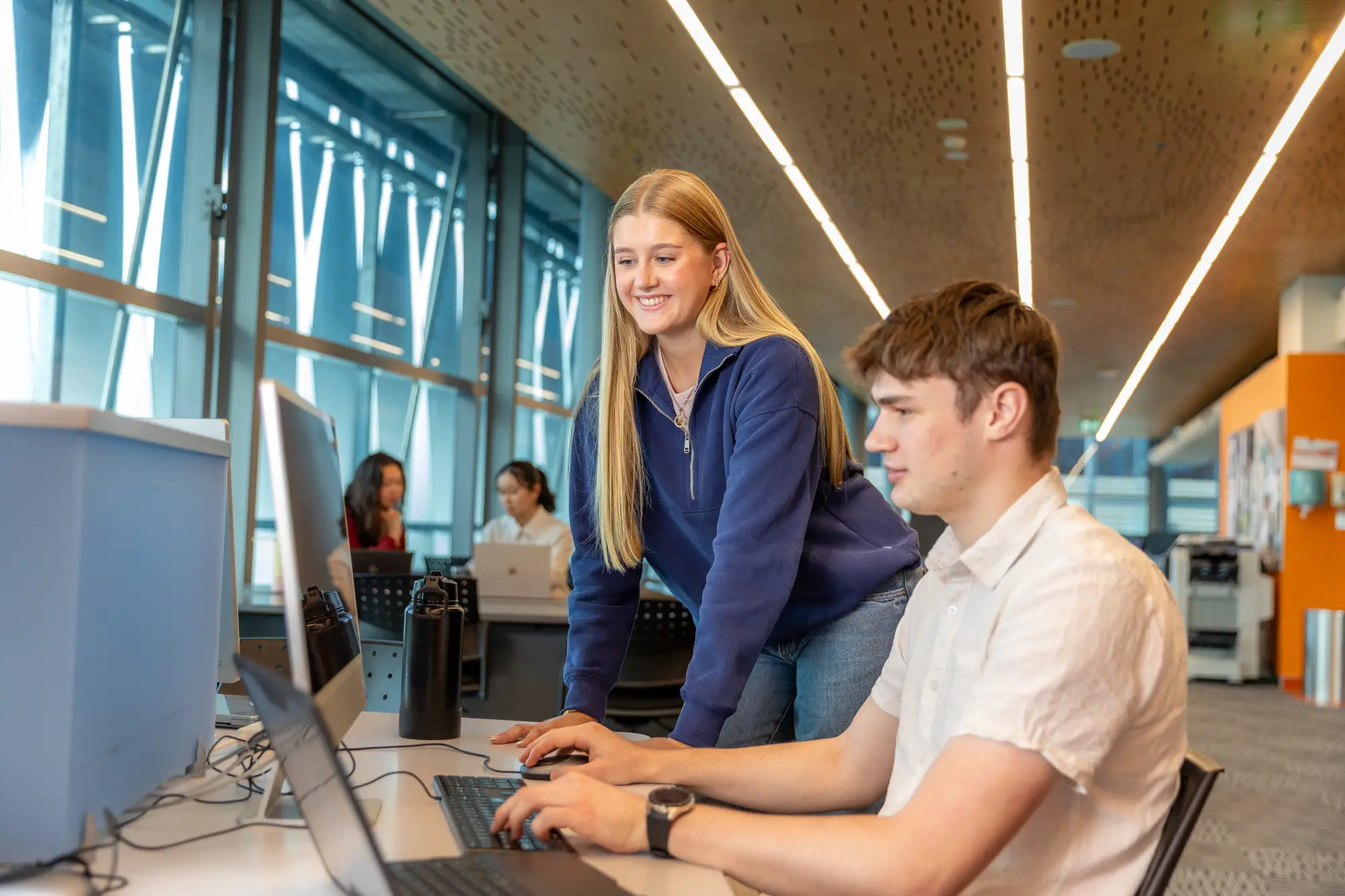 students-studying-on-library-computer